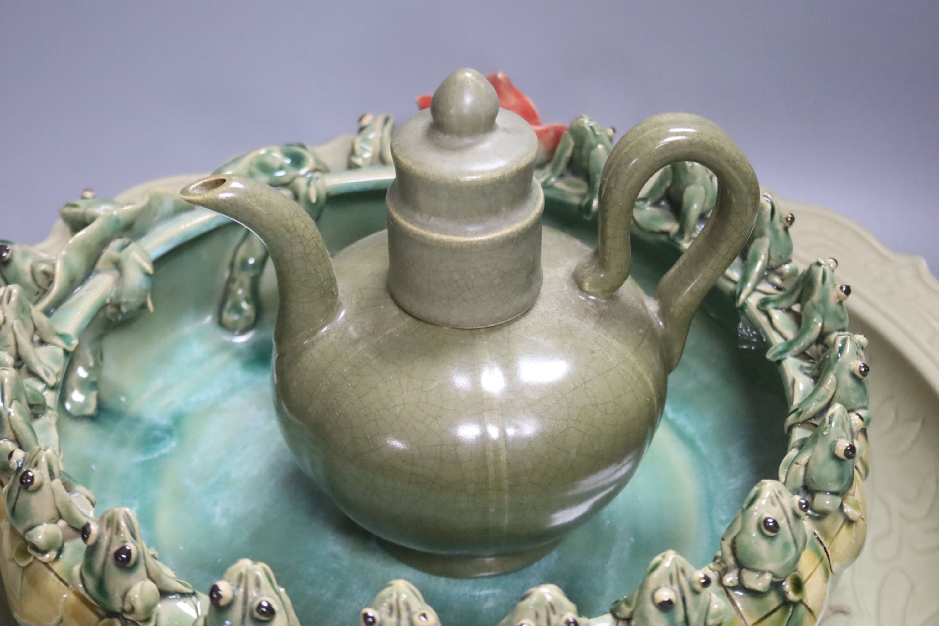 A large Chinese celadon glazed dish, a Chinese green crackle glaze ewer and cover and a 'frog pond' bowl (3)